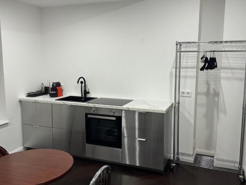 a kitchen with a sink and a counter top at Notorious Design Apartments - near Kärntner Straße in Vienna