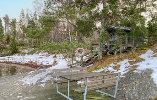 a wooden bench sitting on top of a wooden deck at 3 Bedroom Amazing Home In Yxlan in Yxlö