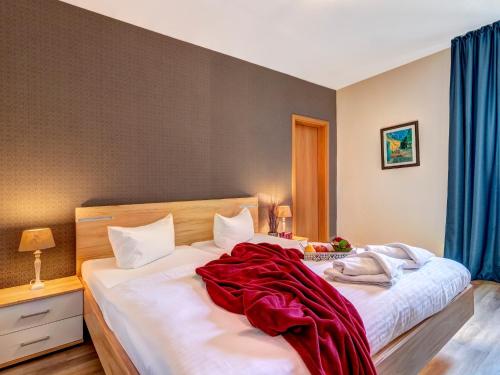 a bedroom with two beds with a red blanket on them at Gartenoase Ahlbeck -01 in Ahlbeck