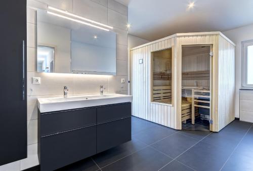 a bathroom with a sink and a large cabinet at Haus Henny mit Sauna in Heringsdorf