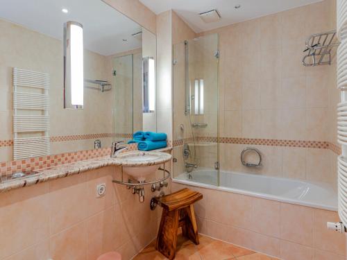 a bathroom with a tub and a sink and a shower at Villa Christiane Wohnung 8 in Heringsdorf