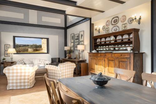 a living room with a table and chairs at Podere La Strega in Siena