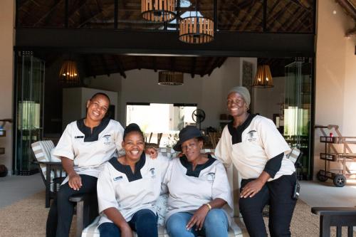 a group of women sitting on a chair at Mologa River Lodge in Rust de Winter