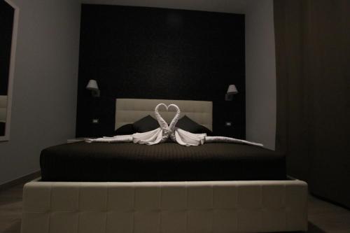 a black and white bedroom with a bed with black sheets at Pianeta Roma 127 in Rome
