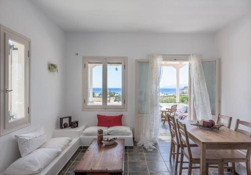 a living room with a white couch and a table at Mylopota apartment IV in Ios Chora