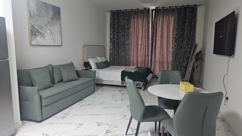 a living room with a couch and a table at Unique studio E16 in Ras al Khaimah