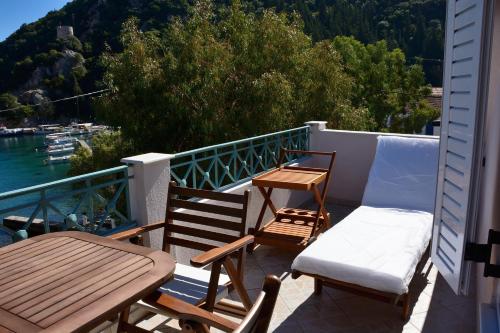 a balcony with two chairs and a table and a bench at Kimataki in Frikes