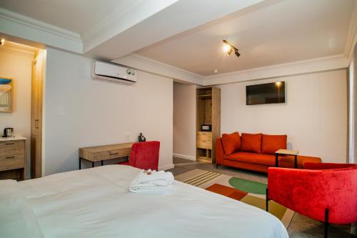 a room with a bed and two chairs and a couch at 9 On Barrack in Cape Town