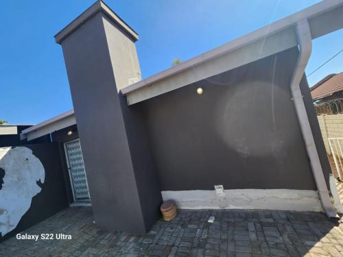 a building with a large open door at Wampex Guest House in Rustenburg