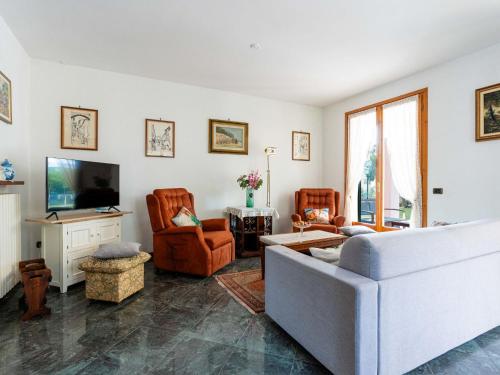 a living room with a couch and chairs and a tv at Holiday Home La Casetta by Interhome in Diano Castello