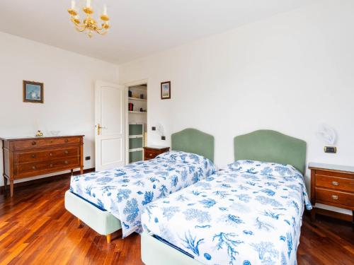a bedroom with two beds with blue and white sheets at Holiday Home La Casetta by Interhome in Diano Castello