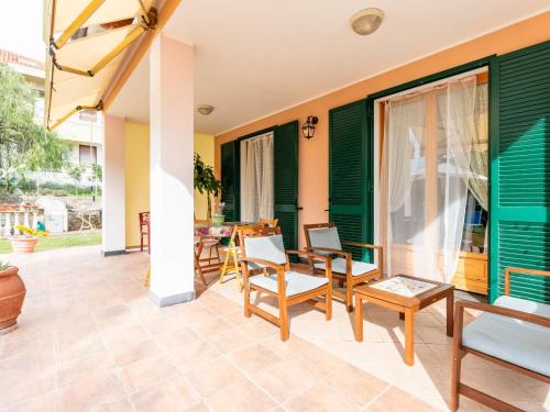a patio with chairs and a table and a table at Holiday Home La Casetta by Interhome in Diano Castello
