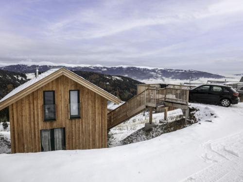 a house with a deck in the snow at Chalet Klippitzrose by Interhome in Klippitztorl