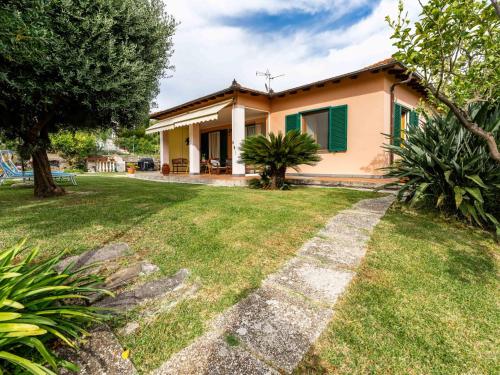 a small house with a green shutters and a yard at Holiday Home La Casetta by Interhome in Diano Castello