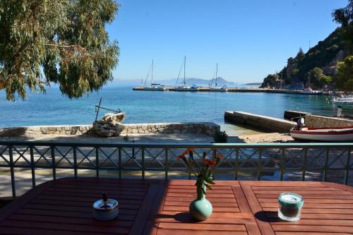 a wooden table with a vase on it next to the water at Kimataki in Frikes