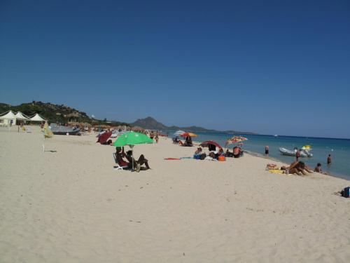 a group of people on a beach with umbrellas at Apartment Appartamento Doria - REI186 by Interhome in Monte Nai