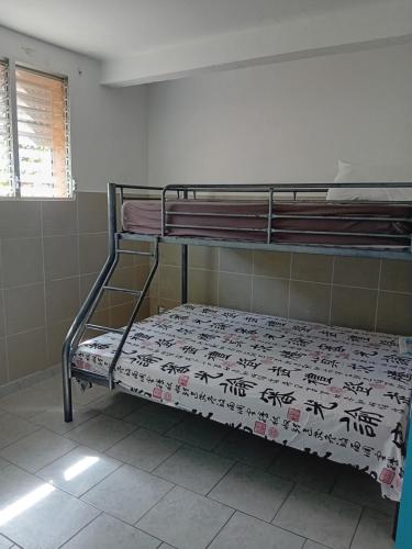 a room with two bunk beds in a room at Entre montagne et mer in Le Morne Rouge