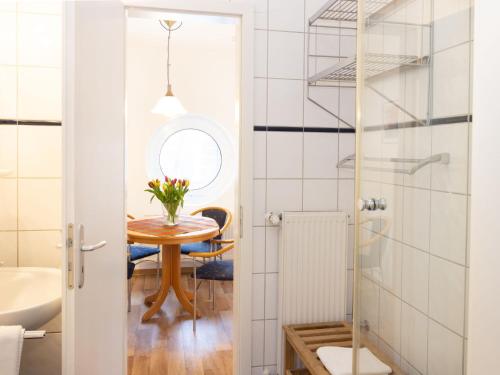 a small bathroom with a table and a mirror at Apartment Jeschek by Interhome in Ostseebad Koserow