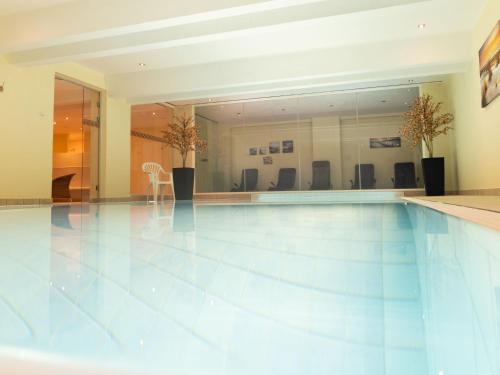 an empty swimming pool with chairs in a building at Apartment Südwind App- 9 by Interhome in Zempin