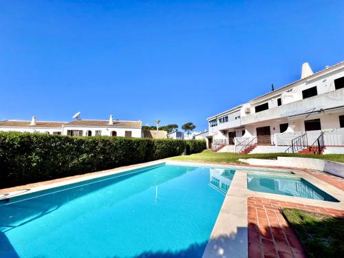 a swimming pool in front of a building at Vilamoura Classic 2 with Pool by Homing in Quarteira