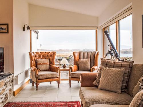 a living room with chairs and a large window at Holiday Home Finnan's Byre by Interhome in Eyre