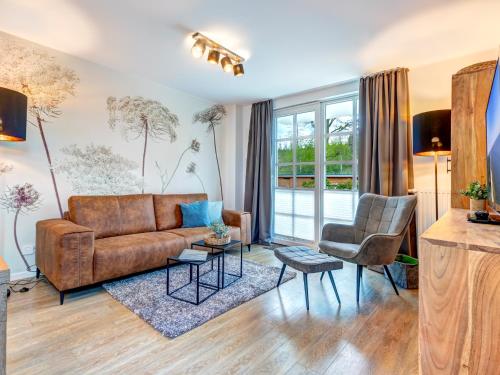a living room with a couch and two chairs at Residenz am Balmer See - BS 43 mit Wellnessbereich in Balm