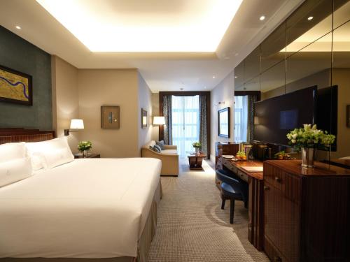 a hotel room with a large bed and a desk at The Beaumont Mayfair in London