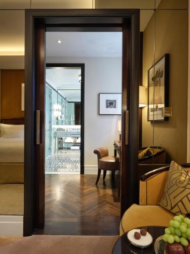 a hotel room with a door leading to a bedroom at The Beaumont Mayfair in London