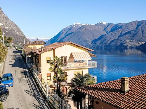 a view of a house and a lake and mountains at Apartment Miralago by Interhome in Oria