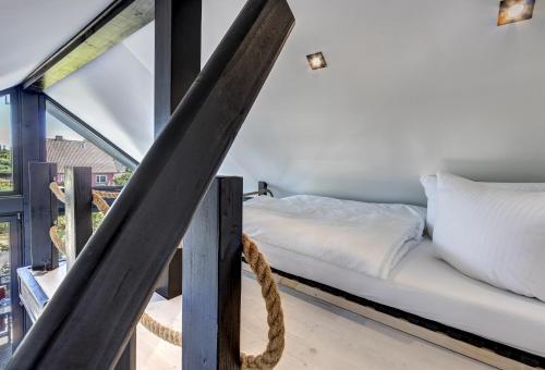 a bed in a room with a large window at Ferienwohnung Carlotta in Trassenheide