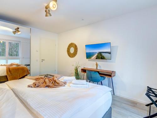 a bedroom with a bed and a desk at Bernsteinquartier BQ0556 Meeresgold in Kolpinsee