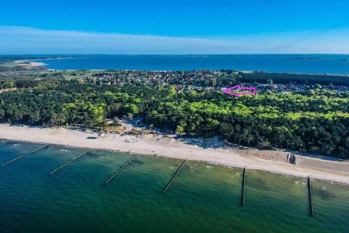 an aerial view of a beach with a pink house at Ferienhaus Inselliebe mit Sauna in Zempin