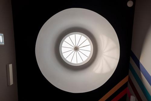 a round window in a room with a wall at CATS Porto Hostel in Porto