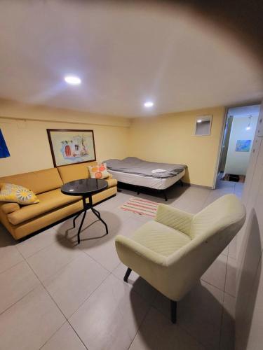 a room with a couch and a bed and a table at Ortal in Tel Aviv