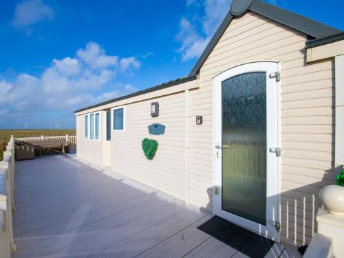 a large white building with a large deck at MP261 Parkdean Camber Sands in Camber