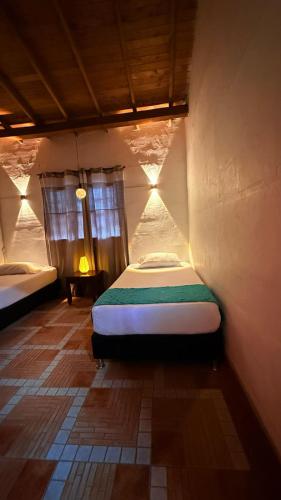 a small bedroom with a bed in a room at Cabaña ideal 5-9 personas cocina, wifi, cerca al parque y campestre in Jardin