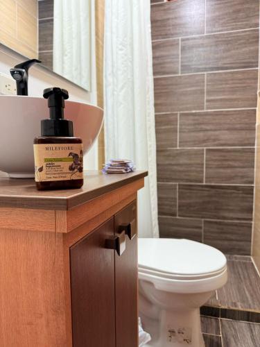 a bathroom with a toilet and a bottle of soap at Cabaña ideal 5-9 personas cocina, wifi, cerca al parque y campestre in Jardin