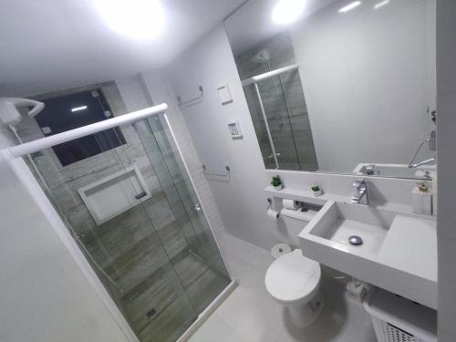 a bathroom with a shower and a toilet and a sink at Apto 2 quartos em frente à praça nova do Imbui Excelente localização in Salvador