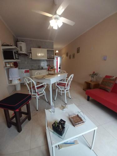 a living room with a couch and a table with chairs at Deptos de Lili in Termas de Río Hondo