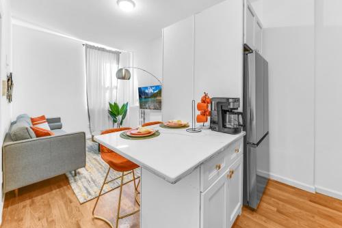 a kitchen with a white counter and a refrigerator at Chic Sunny Retreat in Park Slope in Brooklyn