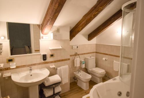 a bathroom with a sink and a toilet and a shower at Hotel Villa Stucky in Mogliano Veneto