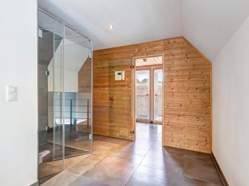 a room with a wooden wall and a glass door at Ferienhaus Rosa in Ostseebad Karlshagen