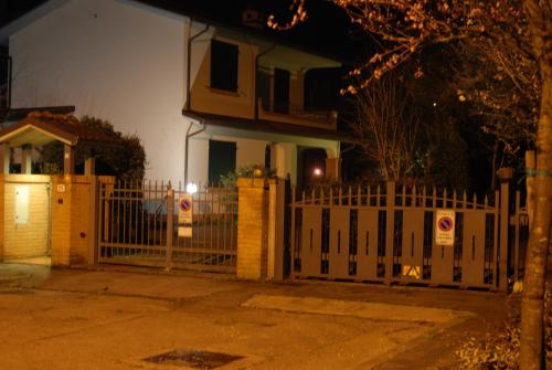 a white fence in front of a house at Il Sole Bed & Breakfast in Forlì