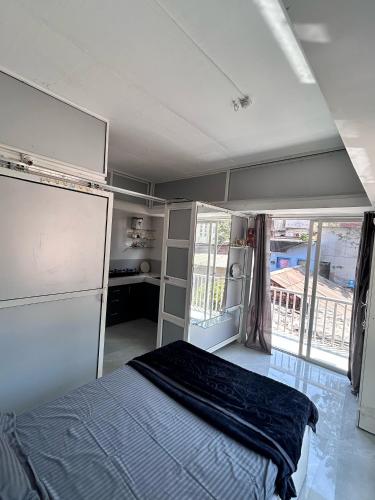 a bedroom with a bed in a room with a window at The Lavish Residency in Panchgani