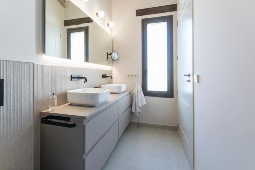 a bathroom with two sinks and a mirror at Casa Adela - Luxury Rural Accommodation in Castellonet
