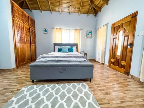 a bedroom with a bed and a wooden floor at Sham Suite in Boscobel