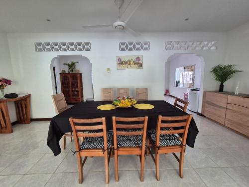 a dining room with a table with a bowl of fruit on it at Kaz Memel in Beau Vallon