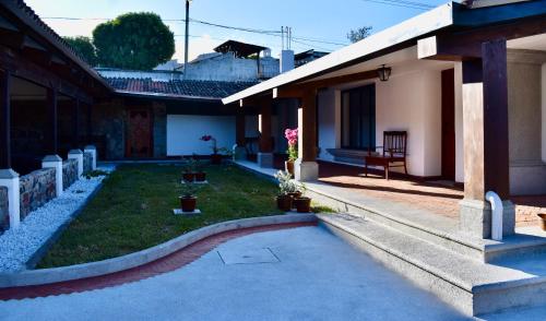 a courtyard of a house with a yard with plants at Villa Cristal in Antigua Guatemala