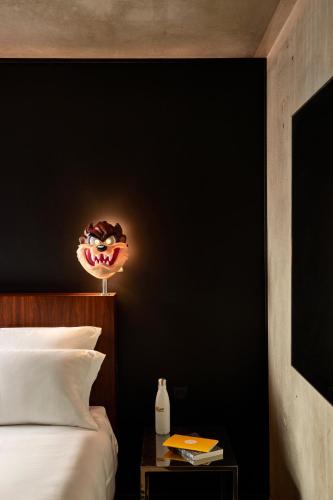 a bedroom with a bed and a black wall at Mama Shelter Paris East in Paris