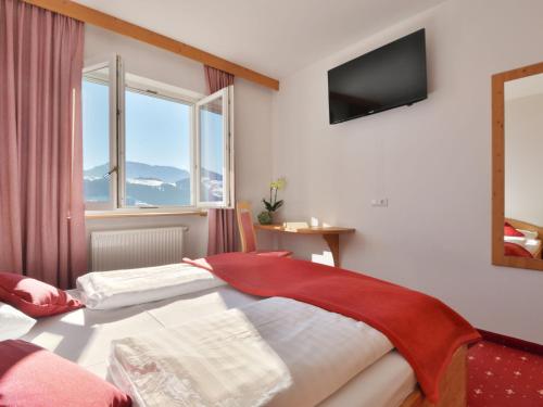 a bedroom with two beds and a television on the wall at Apartment Residence Egger - n-102 by Interhome in Villandro